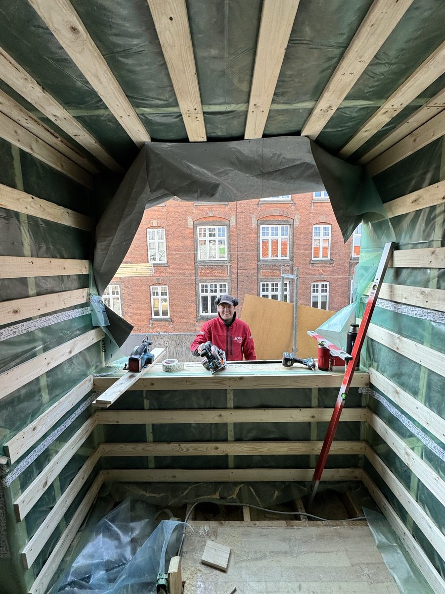 Inde i en nyrejst kvist med udsigt til mursten